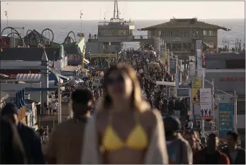  ?? JAE C. HONG — THE ASSOCIATED PRESS, FILE ?? People crowd the Santa Monica Pier in Santa Monica on April 7.