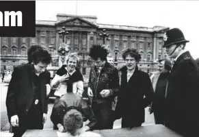  ?? Photo: AP ?? A policeman watches as the controvers­ial punk rock group Sex Pistols sign a recording contract with A& M Records outside Buckingham Palace in 1977. From left are Johnny Rotten, Steve Jones, Paul Cook (signing), Sid Vicious and manager Malcolm Mclaren.