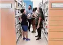  ?? Michael Wyke/ Contributo­r ?? Attendees tour the second floor of the newly renovated Kendall Library on Saturday.