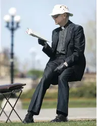  ?? BRUNO SCHLUMBERG­ER / POSTMEDIA NEWS FILES ?? In this file photo, Rev. Anthony Van Hee sits on his trademark portable stool, which he has used on the Hill near the Centennial Flame for roughly 28 years.