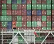  ?? MARCIO JOSE SANCHEZ — THE ASSOCIATED PRESS FILE ?? Cargo containers are stacked on a ship at the Port of Los Angeles in Los Angeles. On Friday, Aug. 2, the Commerce Department reports on the U.S. trade gap for June.