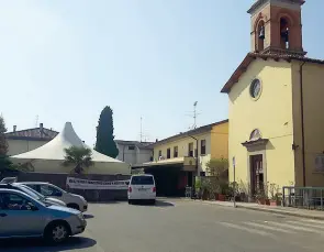  ??  ?? La chiesa di Vicofaro A sinistra, don Biancalani con alcuni dei migranti ospiti della sua parrocchia Sopra, partita a calcio nel cortile