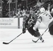  ?? Andy Cross, The Denver Post ?? Avalanche center Nathan Mackinnon ) takes the puck down ice against Vegas defenseman Brayden Mcnabb in a preseason game on Tuesday night at the Pepsi Center.