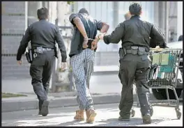  ?? Mark Boster Los Angeles Times ?? POLICE arrest a man during a skid row cleanup in 2016. From 2011 to 2016, arrests of homeless people in L.A. rose 31%, a Times analysis of police data shows.