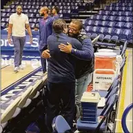  ?? David Borges / Hearst Connecticu­t Media ?? Maurice Clarett embraces UConn men’s basketball assistant coach Tom Moore prior to Saturday’s game at Xavier.