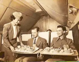  ??  ?? Becky serves inflight meal to passengers.