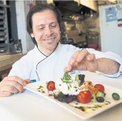  ?? NIKKI WESLEY METROLAND ?? Mike DiBiase puts the finishing touches on an appetizer salad in his kitchen. The Milton chef has been chosen to represent Ontario in the Culinary World Cup.