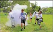  ?? DIGITAL FIRST MEDIA FILE PHOTO ?? Volunteers cover runners in purple powder during a color run fundraiser at West-Mont Christian Academy in North Coventry.