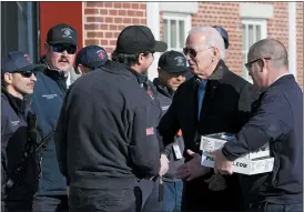  ?? SUSAN WALSH — THE ASSOCIATED PRESS ?? President Joe Biden shakes hands with Nantucket Fire Department Captain Nate Barber, center, during a visit to the Nantucket Fire Department on Thanksgivi­ng Day in Nantucket, Mass., Thursday.