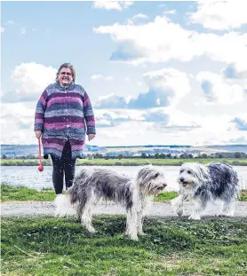  ??  ?? Shona Black, left, and Agnes Widley (and their dogs) in two of the portraits captured by Kinross photograph­er Ross Mitchell.