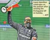  ?? — AFP ?? Lewis Hamilton celebrates on the podium after winning the Portuguese GP on Sunday.