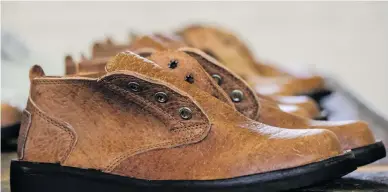  ?? Picture: AFP ?? HANDMADE. Pairs of shoes on the production line of the Courteney Boot company in Bulawayo last month. Founded in 1993, the firm has recently ramped up production to 30 pairs a day.