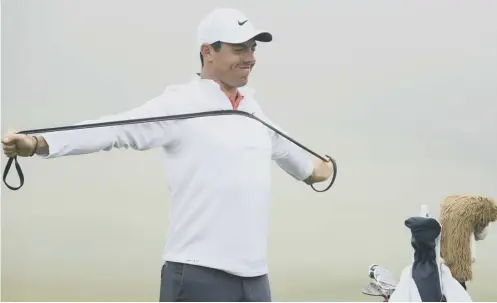  ??  ?? 0 Rory Mcilroy stretches on the practice range ahead of the US Open, which tees off at Shinnecock Hills today.