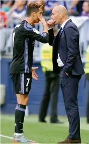  ?? AFP ?? Real Madrid coach Zinedine Zidane with Cristiano Ronaldo at the touchline.