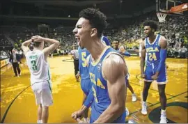  ?? Chris Pietsch Associated Press ?? UCLA’S JULES BERNARD, center, and Jalen Hill exult at the end of regulation on Thursday night, when the Bruins made up nine points in the last 51 seconds.