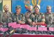  ?? HT PHOTO ?? BSF and Punjab Police officials showing the weapons recovered from Ajnala sector on Sunday.