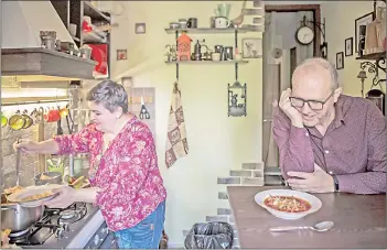  ??  ?? Chadaieva ladles borscht into a bowl for a meal with her family in Kyiv.