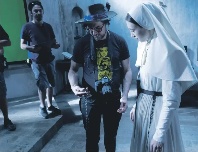 ??  ?? Corin Hardy directs Taissa Farmiga, who plays Sister Irene, on the set of ‘The Nun’, the fifth film in ‘The Conjuring’ franchise