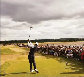  ?? Gerald Herbert / Associated Press ?? Tiger Woods of the US plays from the 12th tee during the first round of the British Open Thursday on the Old Course at St. Andrews, Scotland.