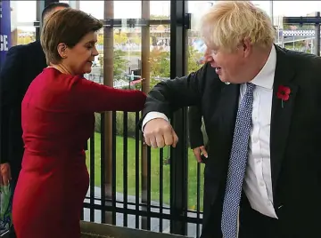  ?? ?? Bumping along: Nicola Sturgeon and Boris Johnson greet one another