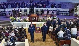  ?? HYOSUB SHIN PHOTOS / AJC ?? Officers carry the ashes of slain officer Chase Maddox at Glen Haven Baptist Church in McDonough on Saturday. Law enforcemen­t officers from around Georgia were among the hundreds at the funeral. Four days after Maddox was killed, his wife delivered the...