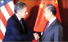  ?? — AFP photo ?? Blinken (left) and Wang shake hands as they meet at the 60th Munich Security Conference (MSC) at the Bayerische­r Hof Hotel in Munich, southern Germany.