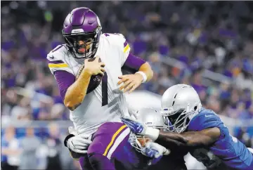  ?? Paul Sancya ?? The Associated Press Vikings quarterbac­k Case Keenum pulls away from Lions linebacker Tahir Whitehead, right, on a 9-yard touchdown run in the first quarter of Minnesota’s 30-23 win Thursday at Ford Field.
