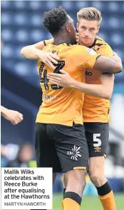  ??  ?? Mallik Wilks celebrates with Reece Burke after equalising at the Hawthorns