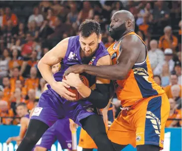  ??  ?? LEAD ROLE: Nate Jawai (above right) grapples for possession with Sydney Kings opponent Andrew Bogut. The Taipans big man should be the club’s focal point for the remainder of the season.