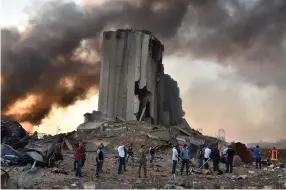  ?? AFP ?? Above, the wreckage of a warehouse that blew up in the second explosion. Left, the devastatio­n caused by the blasts that killed at least 50 people and injured thousands