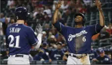  ??  ?? Milwaukee Brewers’ Travis Shaw (21) celebrates his two-run home run against the Arizona Diamondbac­ks with teammate Lorenzo Cain (6) during the first inning of a baseball game on Wednesday, in Phoenix. AP PHOTO/ROSS D. FRANKLIN