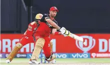  ?? Courtesy: IPL ?? Glenn Maxwell of Bangalore plays a switch-hit against Punjab at Sharjah Stadium, which has produced low scores.
