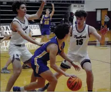  ?? Graham Thomas/Siloam Sunday ?? Springs senior Max Perkins, left, and sophomore Dalton Newman trap a Mountain Home player in front of the Siloam Springs bench during the second half Friday at Panther Activity Center. Mountain Home defeated the Panthers 53-47.