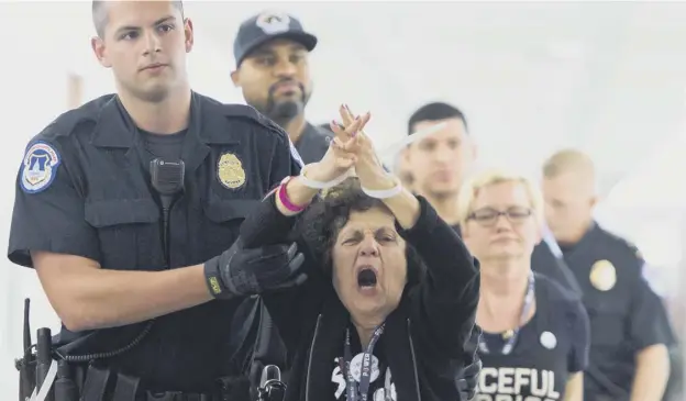  ?? PICTURES: GETTY IMAGES ?? Police arrest demonstrat­ors for protesting against Brett Kavanaugh’s nomination as an associate justice on the Supreme Court