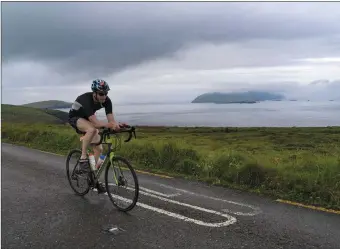  ??  ?? John Long cycling along Slea Head. Photo by Valerie O’Sullivan