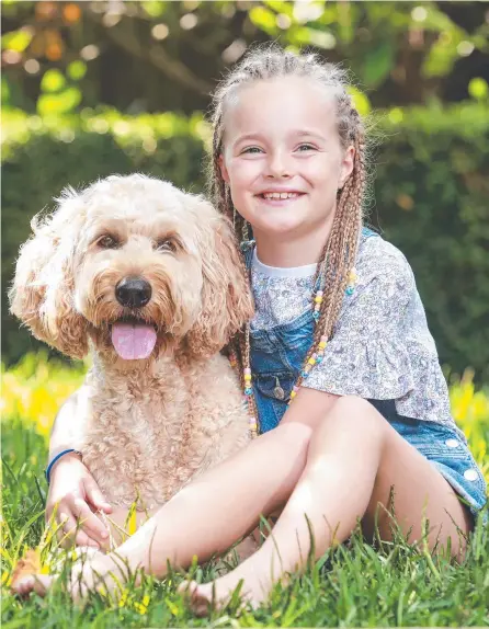  ?? ?? Letti Kortum, 8, with groodle, Rosie, who her mum, Marina Kortum, bought in 2019 for $3500. Picture: Justin Lloyd