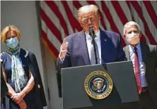  ?? AFP via Getty Images file photo ?? President Donald Trump speaks in May near coronaviru­s task force members Deborah Birx and Anthony Fauci.