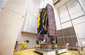  ?? M.PEDOUSSAUT AP ?? NASA’s James Webb Space Telescope is secured on top of the Ariane 5 rocket that will launch it to space from Europe’s Spaceport in French Guiana, now planned for Saturday.