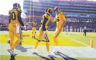  ?? Carlos Avila Gonzalez / The Chronicle ?? Jared Goff (right) celebrates a touchdown pass with Brandin Cooks (12). Goff also had a scoring pass to Todd Gurley (30) during the Rams’ seventh consecutiv­e victory this season.