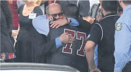  ??  ?? Mourners attend the funeral of Aaron Feis who was the football coach at Marjory Stoneman Douglas High School at Church by the Glades on Feb 22, in Coral Springs, Florida. Mr Feis was killed along with 16 other people by 19-year-old former student...