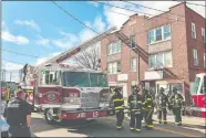  ?? TIM COOK/THE DAY ?? Jordan Fire Company’s ladder truck W15 assists the New London Fire Department with a smoke investigat­ion on Truman Street Tuesday.