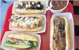  ?? MIKE MAYO / STAFF ?? Hotdog-Opolis in Boca Raton offers a gut-busting assortment of hot dogs and exotic sausages in a low-key strip-mall setting.