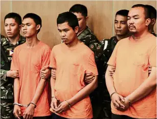  ?? — EPA ?? In custody: Davao bombing suspects (from left) Wendel, Musali and TJ standing for presentati­on during a press conference at a military camp in Quezon City, Philippine­s.