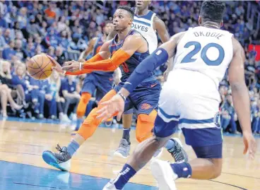  ?? [PHOTO BY SARAH PHIPPS, THE OKLAHOMAN] ?? Oklahoma City’s Russell Westbrook passes the ball as Minnesota’s Josh Okogie defends during Sunday’s game at the Chesapeake Energy Arena. The Timberwolv­es won, 114-112.