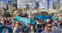  ?? DEAN RUTZ — THE SEATTLE TIMES VIA AP ?? Soccer fans gather along the downtown Seattle waterfront to cheer the awarding of FIFA 2026World Cup games to Seattle, Thursday in Seattle.