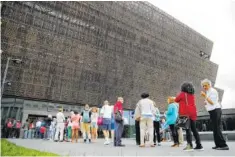  ?? ASSOCIATED PRESS FILE PHOTO ?? People wait in line to enter the Smithsonia­n National Museum of AfricanAme­rican History and Culture on the National Mall in Washington.