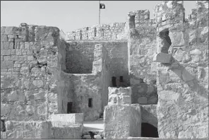  ?? AP ?? An Islamic State flag flies over a castle in the ancient Syrian town of Palmyra, which the militants overran last week.