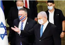  ?? — AFP photo ?? Pompeo (left) and Netanyahu arrive wearing protective masks to make a joint statement to the press after meeting in Jerusalem.