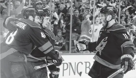  ?? ETHAN HYMAN ehyman@newsobserv­er.com ?? Carolina’s Jordan Martinook (48) and Jordan Staal (11) celebrate with Seth Jarvis after Jarvis scored in the third period of the Hurricanes’ 5-3 victory over the Islanders in the first round of the Stanley Cup playoffs at PNC Arena in Raleigh on Monday.