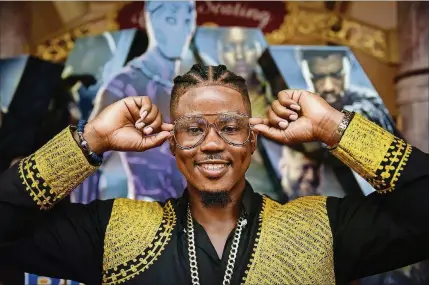  ?? PHOTOS BY STAFF PHOTOGRAPH­ER MELANIE BELL ?? Henbo Squeazy, aka “The Palm Beach Nigerian,” in full fan attire, was among the fans who dressed in African attire or looks inspired by the movie at the “Black Panther” premiere at CityPlace.